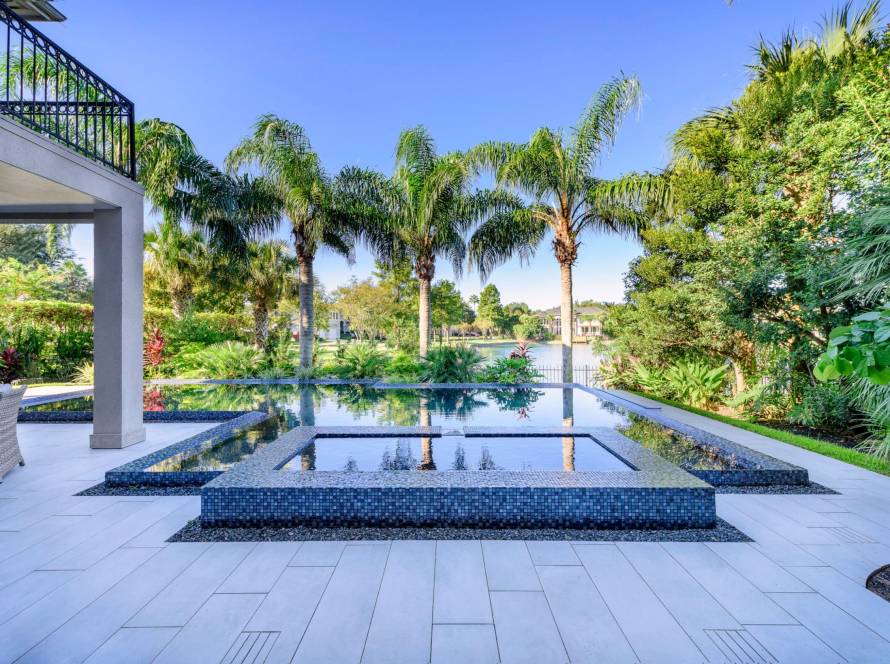 Pool deck pavers – Pool deck pavers installed around swimming pool – Bayside Pavers
