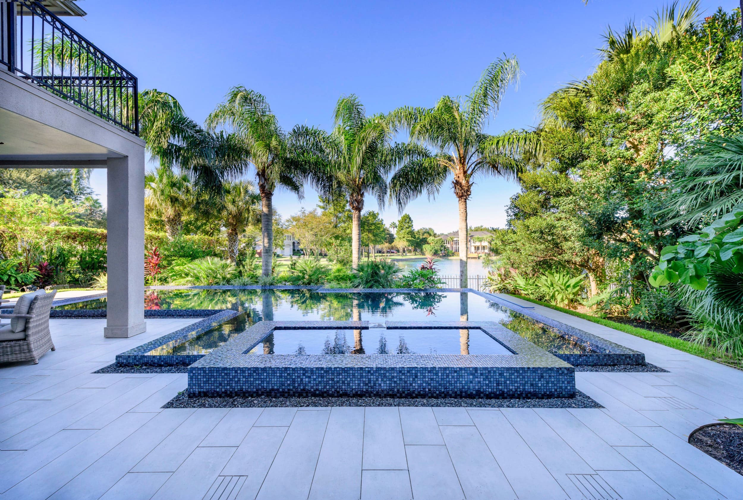 Pool deck pavers – Pool deck pavers installed around swimming pool – Bayside Pavers