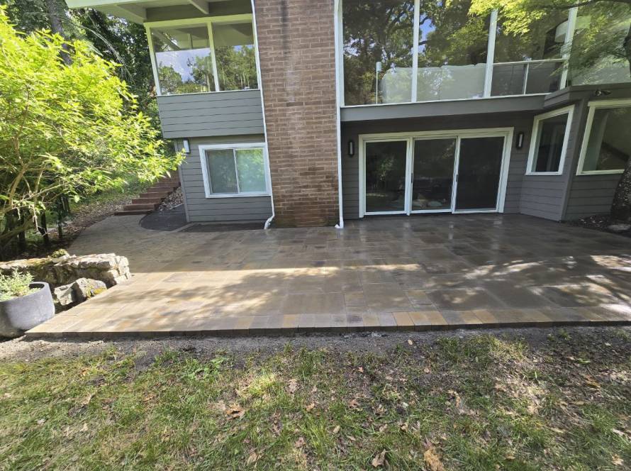 Luxury backyard paver patio with seating area